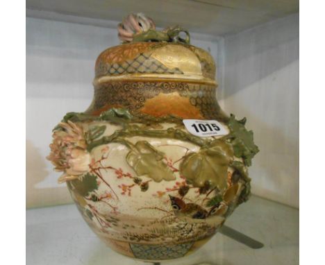 A late Satsuma jar and cover decorated with hand painted applied birds in foliage