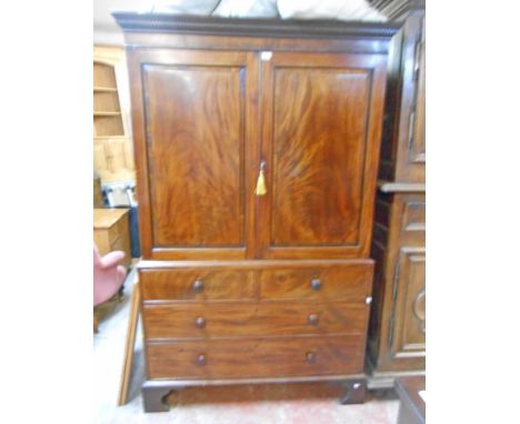 A 4' 1" 19th Century flame mahogany veneered two part linen press with Greek key cornice, the converted interior now hanging 