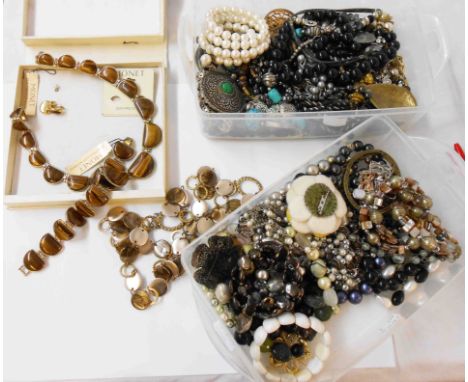 A large quantity of assorted costume jewellery including Monet, tiger's-eye set necklace and bracelet etc.