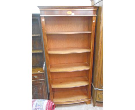 A 36" reproduction mahogany Edwardian style bow front five shelf open bookcase with dentil cornice, set on bracket feet