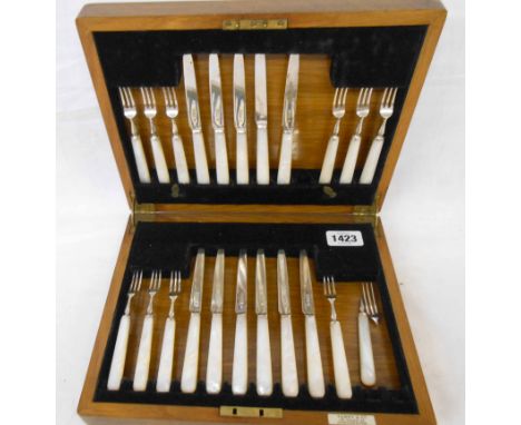 An oak cased part set of silver and mother-of-pearl handled fruit knives and forks, comprising eleven knives, ten forks and o