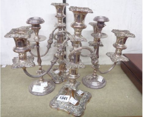A pair of twin branch three light candelabra with detachable nozzles and stems - sold with a pair of slender candlesticks