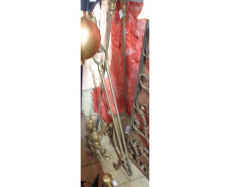 A set of brass fire tools and andirons