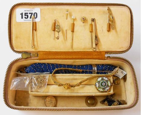 A vintage jewellery case containing yellow metal and other jewellery items including stick pins and bar brooches, etc.