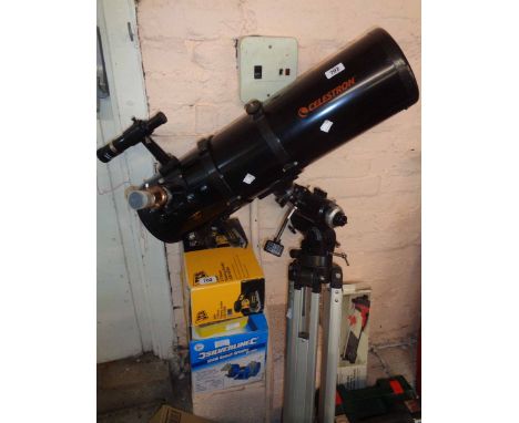 A Celestron large telescope with tripod, books and accessories