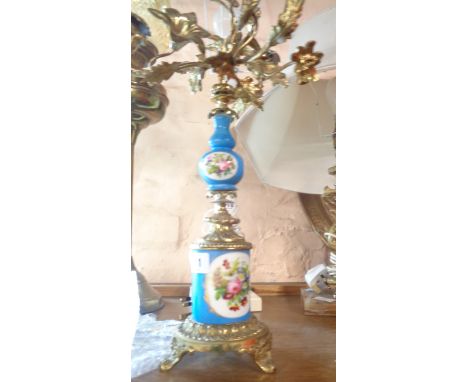 A decorative gilt brass four branch candleabrum with hand painted ceramic mounts