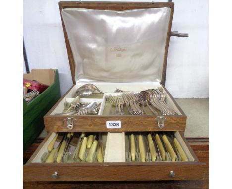 An oak canteen containing a part twelve place setting of Christofle silver plated cutlery with large ladle and associated kni