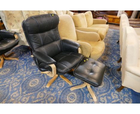 Modern leather upholstered armchair and footstool 