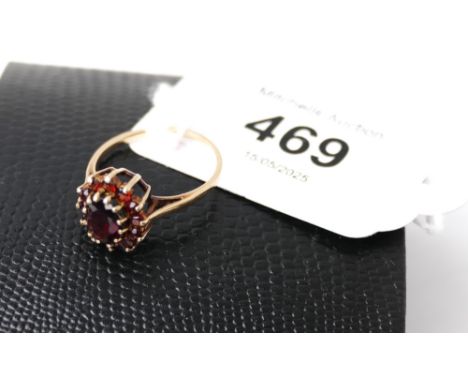 9 ct gold ring with ruby coloured stones, +/- 1.9 grams
