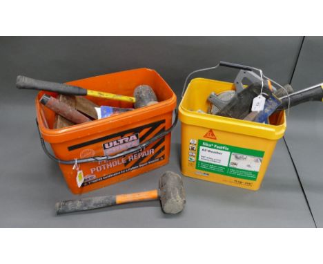 Two tubs of tools that include rubber mallets, trowels, fabric tape measure etc.