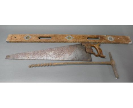 Vintage wooden spirit level, long auger drill and vintage hand saw.