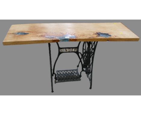 Oak and resin topped table with Singer sewing machine treadle base, measuring 136cm wide, 46cm deep, 76cm high.