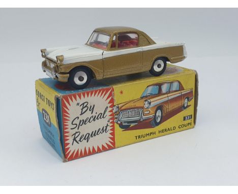 A boxed Corgi Toys No.231 gold and white Triumph Herald with club leaflet, Nr M-M, box Ex 