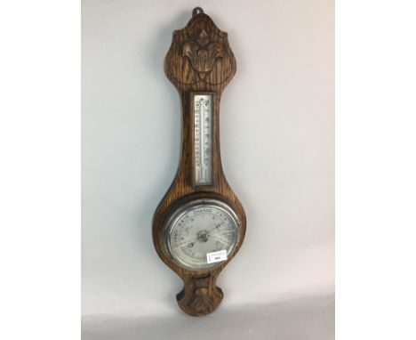 OAK ANEROID BAROMETER AND THERMOMETER, in a carved case