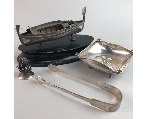 CONTINENTAL SILVER MODEL OF A BOAT, 15cm long, on stand, along with a pair of silver tongs and a square dish (3)