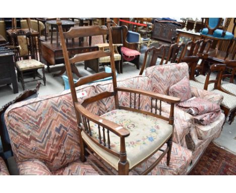 An Edwardian ladder back arm chair with wool work seat