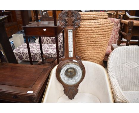 An early 20th century oak banjo barometer, with aneroid barometer dial, thermometer scale and stipple carved detail