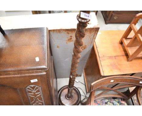 A 1940's oak barley twist standard lamp, with circular base
