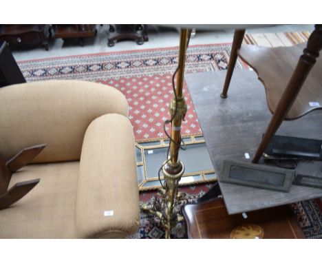 An ornate brass standard lamp having copper detailing