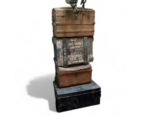 A stack of vintage luggage including an early 20th century RAF Strategic Air Command cargo box marked 'S.A.C. Wood. P 4047930