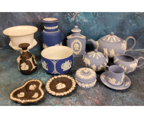 A Wedgwood Blue Jasperware three piece tea service, each sprigged in white, the teapot 15cm high, impressed marks, 20th centu