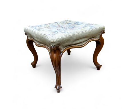 A Victorian walnut shaped rectangular foot stool, tapestry top, cabriole legs, 45cm high, 52cm wide, c.1870 