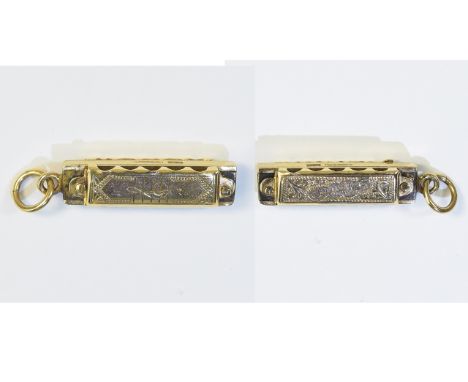 A Bespoke 9ct Gold Charm In The Form of a Miniature Harmonica which plays. Fully Hallmarked for 9ct Gold, A Well Made and Int