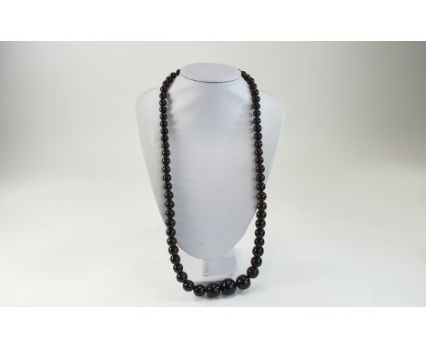 A Vintage Reconstituted Cherry Amber Beaded Long Necklace, with 9ct Gold Clasp, Marked 9ct. 28 Inches In Length. 90.9 grams. 