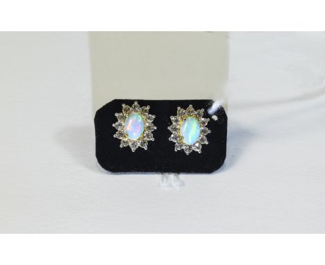 Natural Opal and White Topaz Stud Earrings, each earring comprising an oval cut Ethiopian opal framed by a row of bright whit