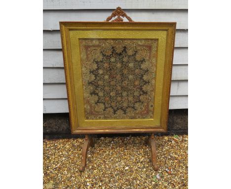 A 19th Century gilt and gesso fire screen with egg and dart and Greek key borders. Set with a highly skilled embroidered silk