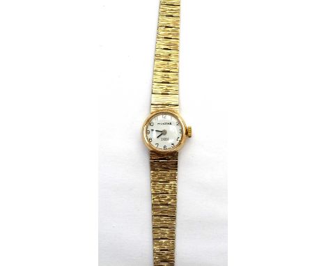 A Montime 9ct yellow gold cocktail watch, the arabic dial fitted manual wind movement, on textured strap, 17.1g gross. 