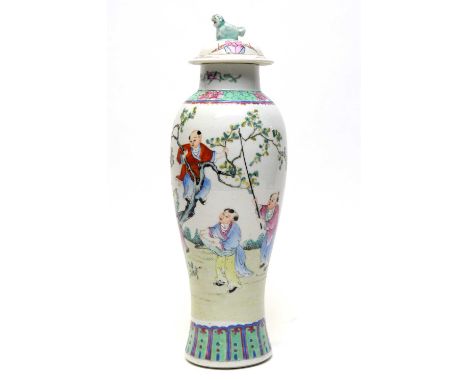 A Chinese famille rose baluster vase and cover, 20th Century, decorated with boys playing in a garden, stencilled seal mark M