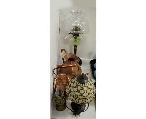 A Victorian copper and brass oil lamp, with clear glass reservoir, clear glass shade and funnel, mounted on a circular glass 