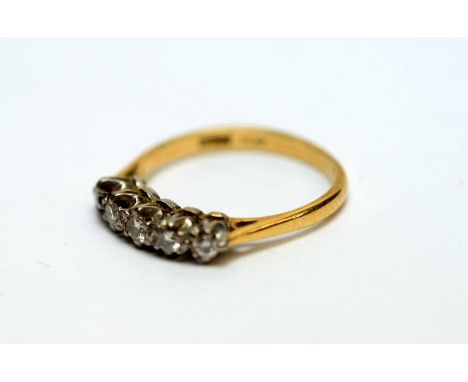 A five stone diamond ring, total diamond weight approximately 0.25carat, the shank stamped 'Plat 18ct', ring size K, 2.6g gro