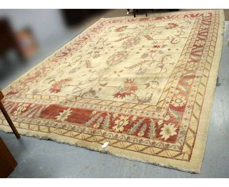 A Ziegler carpet, the ivory ground with foliate decoration in red, enclosed by repeating foliate and geometric borders, 428 x