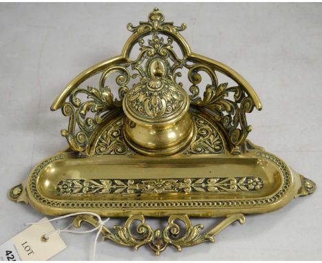A Victorian brass inkstand, formed of central inkwell with oblong pen rest, with impressed maker's mark 'WT &amp; S' to under