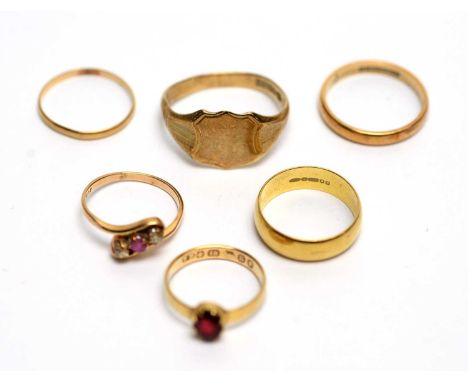 A garnet set 18ct yellow gold ring, 1.9g gross; an 18ct gold wedding band, 3.9g; a ruby and diamond ring, the shank stamped 5