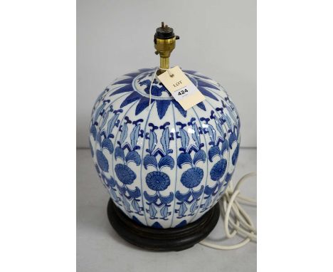 An Oriental blue and white pumpkin-form table lamp, on a stepped circular ebonised wood base, approximately 34cms high, with 