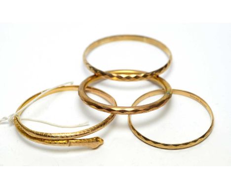 A 9ct yellow gold snake pattern bangle, 13.9g; and three plated metal bangles. 