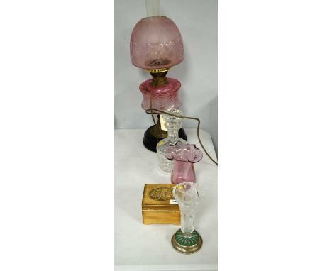 A Victorian oil lamp, with ombre glass reservoir and florally decorated pink glass shade, on stepped black base, 61cms high o