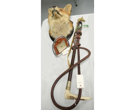 A mid 20th Century taxidermy fox head, mounted to an ebonised wood shield-shaped plaque, with presentation cartouche inscribe