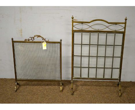 A Victorian brass firescreen, with leaded glass panel, 80cm high; together with a smaller brass firescreen. (2)