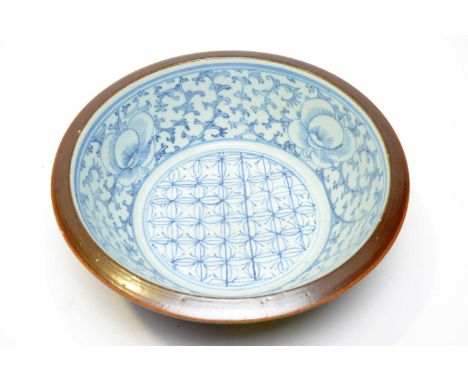 A 19th Century Chinese Batavian ware small basin, with blue and white trellis and foliate scroll interior, 'cafe au lait' ext