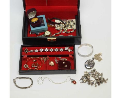 A selection of silver and other jewellery, including a charm bracelet, a locket, and amber ring, and other items.