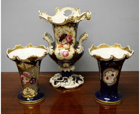 A 19th Century ceramic twin-handled pedestal vase, likely Coalport, painted with a panel of flower and fruit, within a gilt a