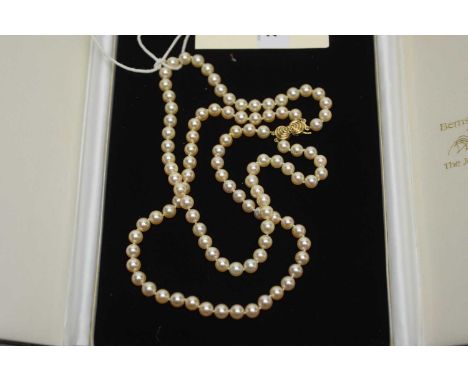 A double row cultured pearl necklace, strung knotted to a 9ct yellow gold clasp, 39cms long. 