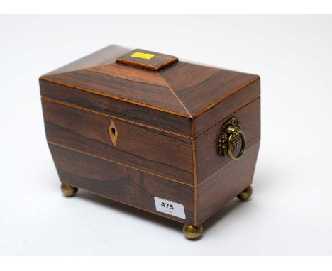 A Victorian banded rosewood sarcophagus tea caddy, with twin brass basket and ring handles, raised on four gilt ball feet, 20