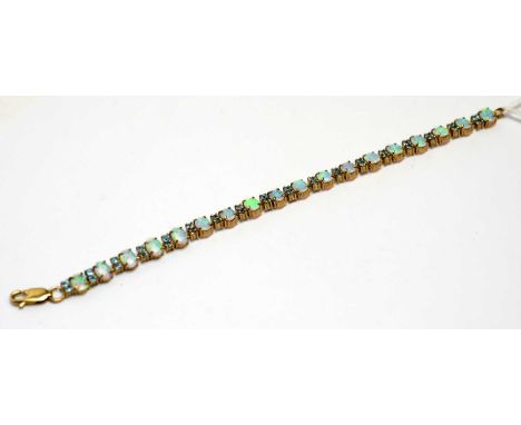 An opal and blue stone bracelet, set with eighteen oval opal cabochons, parted by pairs of blue stones (probably zircon), in 