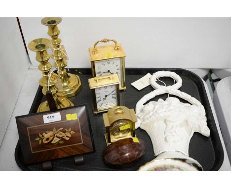 A brass cased Imhof Swiss carriage clock; together with two small brass cased carriage clocks; a pair of brass candlesticks; 