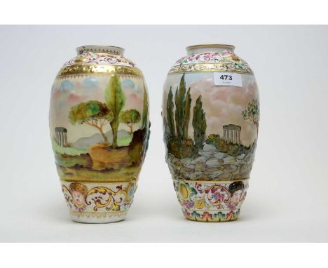 A pair of 20th Century Italian ceramic vases, each moulded and painted with panoramic classical landscape scenes, 23cms high.